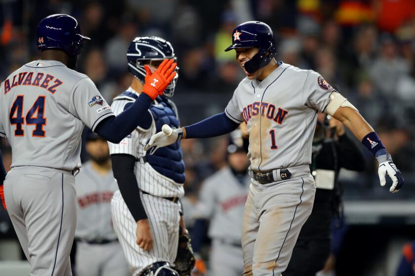 BRONX, NY - OCTOBER 17: Carlos Correa #1 of the Houston Astros is greeted by teammate Yordan Alvarez #44 after hitting a three-run home run in the sixth inning during Game 4 of the ALCS between the Houston Astros and the New York Yankees at Yankee Stadium on Thursday, October 17, 2019 in the Bronx borough of New York City. (Photo by Alex Trautwig/MLB Photos via Getty Images)
