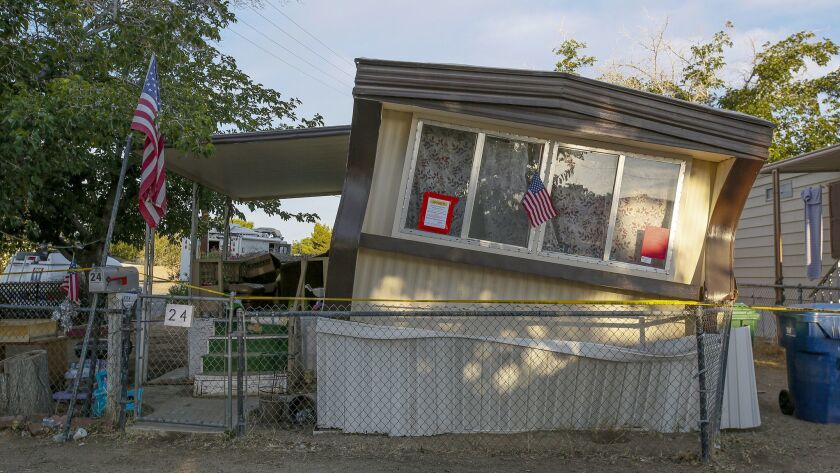 Authorities place a red-tag warning on a mobile home in the Trousdale Estates in Ridgecrest, Calif., that was dislodged from its foundation by Thursday's 6.4 magnitude earthquake.