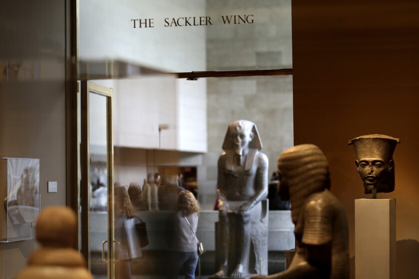 FILE - A sign with the Sackler name is displayed at the Metropolitan Museum of Art in New York, Thursday, Jan. 17, 2019. The Metropolitan Museum of Art is dropping the Sackler name from seven exhibition spaces amid growing outrage over the role the family may have played in the opioid crisis. (AP Photo/Seth Wenig, File)