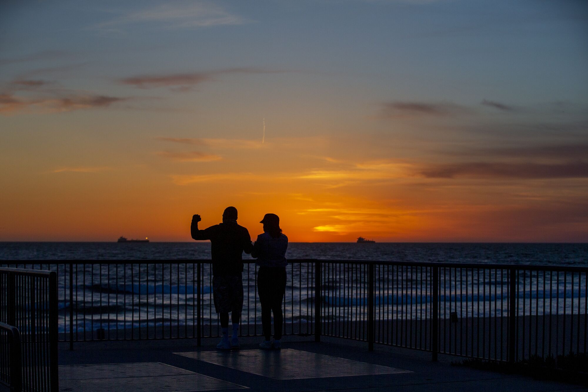 Selron Bowdry and Kayla Taft watch the sunset at Bruce's Beach in Manhattan Beach.