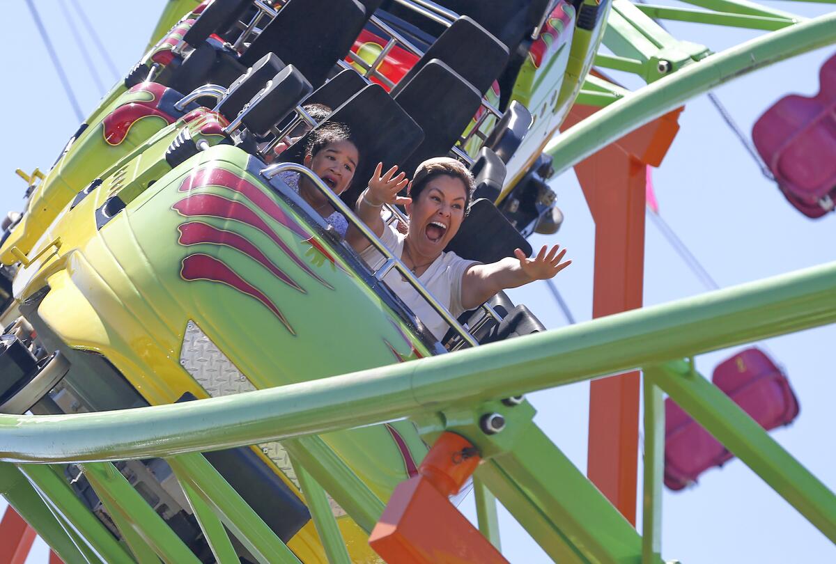 Fairgoers ride on the new Raptor roller coaster Friday on opening day of the Orange County Fair in Costa Mesa.