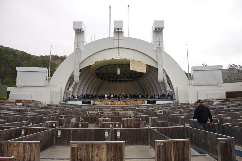 HOLLYWOOD, CA - MAY 12: The team prepares onstage at the Hollywood Bowl for morning rehearsal with Music & Artistic Director of the Los Angeles Philharmonic Gustavo Dudamel at The Hollywood Bowl as the sleeping venue is rousing after 18 months of pandemic-induced hibernation. A behind-the-scenes look at what it takes, reveals a Los Angeles Philharmonic rehearsal, buzzing like never before. Hollywood Bowl on Wednesday, May 12, 2021 in Hollywood, CA. ({a} / Los Angeles Times).