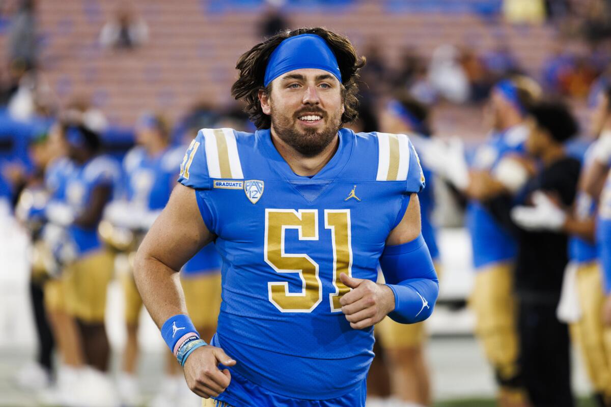 UCLA long snapper Jack Landherr runs onto the field before a game against USC at the Rose Bowl on Nov. 19.