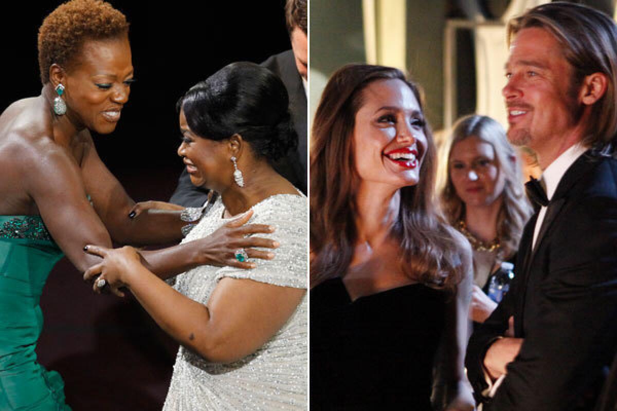 Viola Davis, far left, congratulates Octavia Spencer who won the Oscar for Best Supporting Actress. Angelina Jolie looks at her boyfriend, Brad Pitt, while backstage at the 84th Annual Academy Awards show.