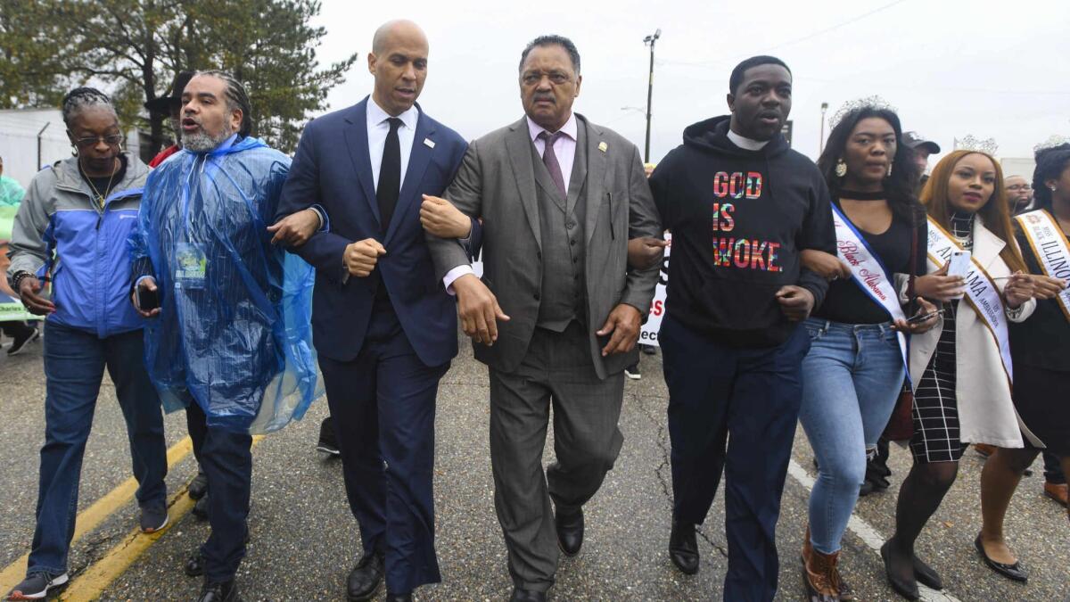 Sen. Cory Booker and the Rev. Jesse Jackson, center, joined activists in March for the Bloody Sunday commemoration in Selma, Ala.