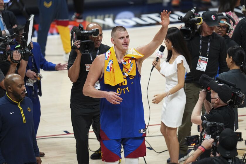 Denver Nuggets center Nikola Jokic, center, gestures to fans after the team's 104-93 victory over the Miami Heat in Game 1 of basketball's NBA Finals, Thursday, June 1, 2023, in Denver. (AP Photo/Jack Dempsey)