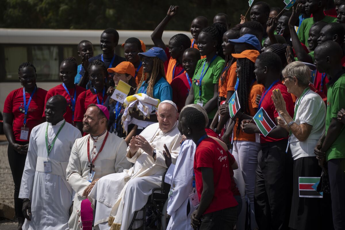 Pope Francis meets with a group of the Catholic faithful from the town of Rumbek, who had walked for more than a week to reach the capital, after he addressed clergy at the St. Theresa Cathedral in Juba, South Sudan Saturday, Feb. 4, 2023. Pope Francis is in South Sudan on the second leg of a six-day trip that started in Congo, hoping to bring comfort and encouragement to two countries that have been riven by poverty, conflicts and what he calls a "colonialist mentality" that has exploited Africa for centuries. (AP Photo/Ben Curtis)
