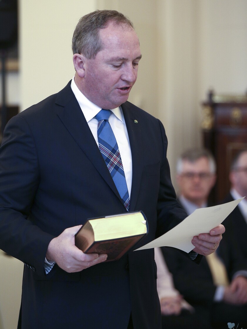 FILE - Barnaby Joyce takes the oath of office as he was sworn in as deputy prime minister at Government House in Canberra, Australia, on July 19, 2016. Joyce has tested positive for the coronavirus while travelling in Washington D.C. He is fully vaccinated and is now isolating in his hotel room. It's unclear what variant he has contracted. (AP Photo/Rob Griffith, File)