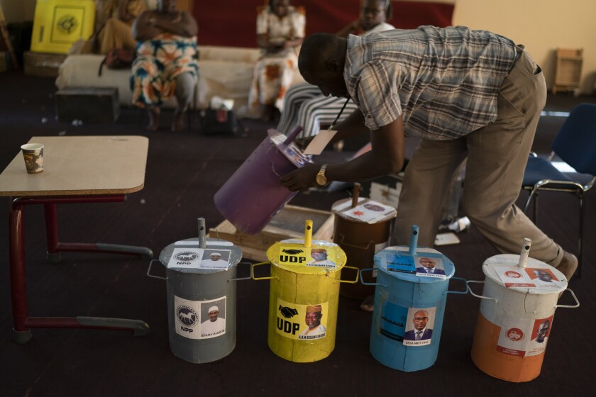Electoral employee lines up the ballot drums in a polling station at a mosque, on the eve of the presidential elections, in Serrekunda, Gambia, Friday, Dec. 3, 2021. Gambians vote on Saturday Dec. 4, in a historic election that will for the first time not have former dictator Yahya Jammeh, who ruled for 22 years, on the ballot. (AP Photo/Leo Correa)
