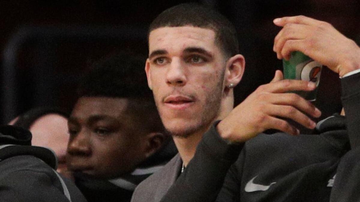 Lakers' Lonzo Ball, center, sits on the bench during the first half against the Memphis Grizzlies on Dec. 27.