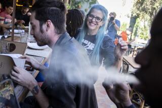 WEST HOLLYWOOD, CALIF. -- TUESDAY, OCTOBER 1, 2019: Joy Cohen of Mt. Washington passes a joint at the Lowell Cafe, a new restaurant and cannabis bar in West Hollywood allows diners to smoke marijuana inside and out thanks to a new license issued by the city in West Hollywood, Calif., on Oct. 1, 2019. (Brian van der Brug / Los Angeles Times)