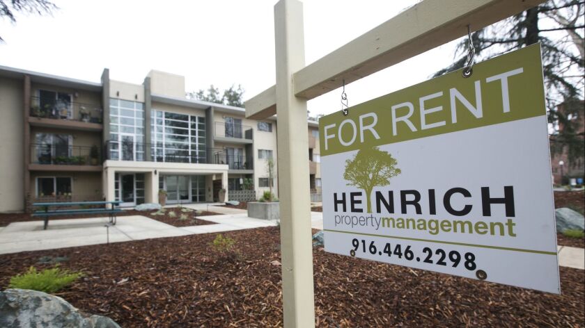 A "For Rent" sign is posted outside an apartment building in Sacramento in January.