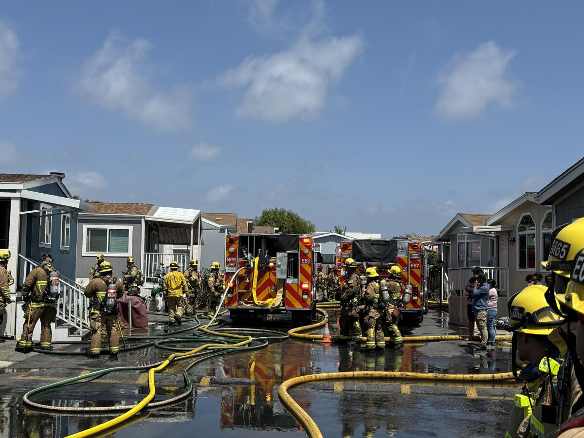 Firefighters respond to a structure fire at the Seacliffe Mobile Home Park Wednesday afternoon.