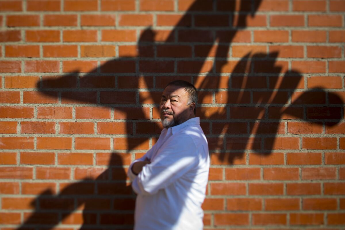 Artist Ai Weiwei, in Southern California for the release of "Human Flow," his documentary about the global refugee crisis, peeked through the shadows in Beverly Hills.