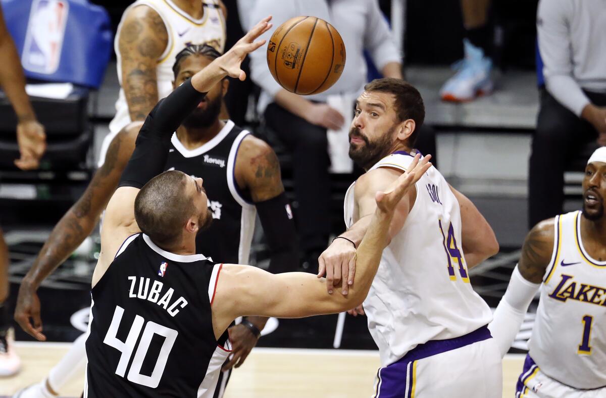 Clippers center Ivica Zubac and Lakers center Marc Gasol fight for a loose ball.