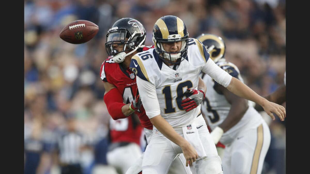 Falcons linebacker Vic Beasley Jr. strips the ball from Rams quarterback Jared Goff. To see more images from the game, click on the photo above.
