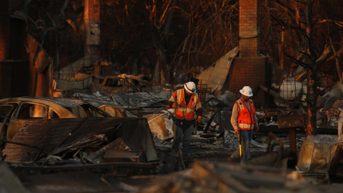 PG&E workers inspect a fire-ravaged neighborhood of Coffey Park in Santa Rosa in October.