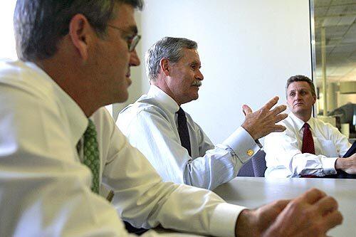 VISIT: Scott Smith, left, president of Tribune Publishing, and Tribune CEO Dennis FitzSimons field questions from Times editors in June. Jeffrey Johnson, then publisher of The Times, is at right.