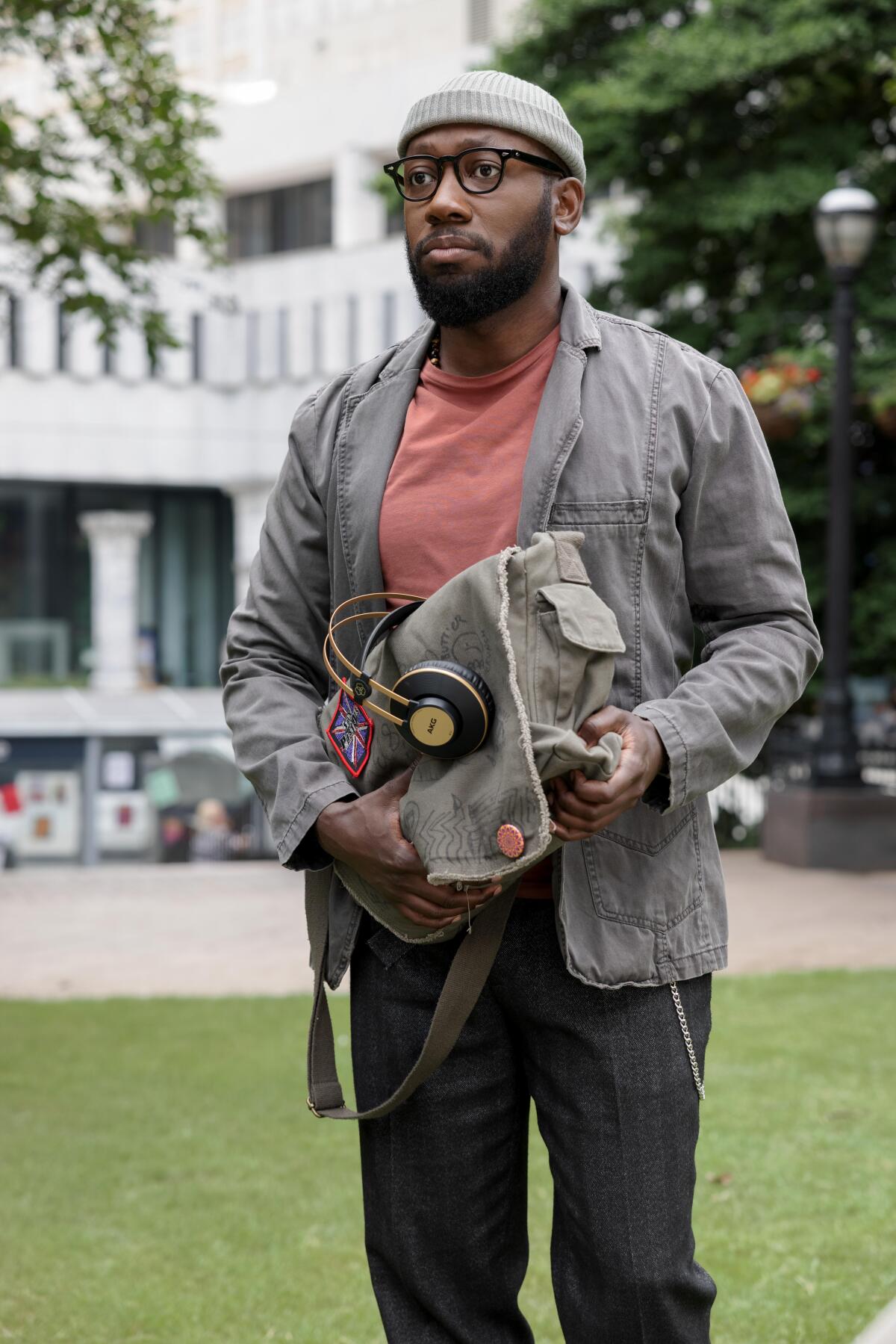 A man in a beanie and jacket standing in a park