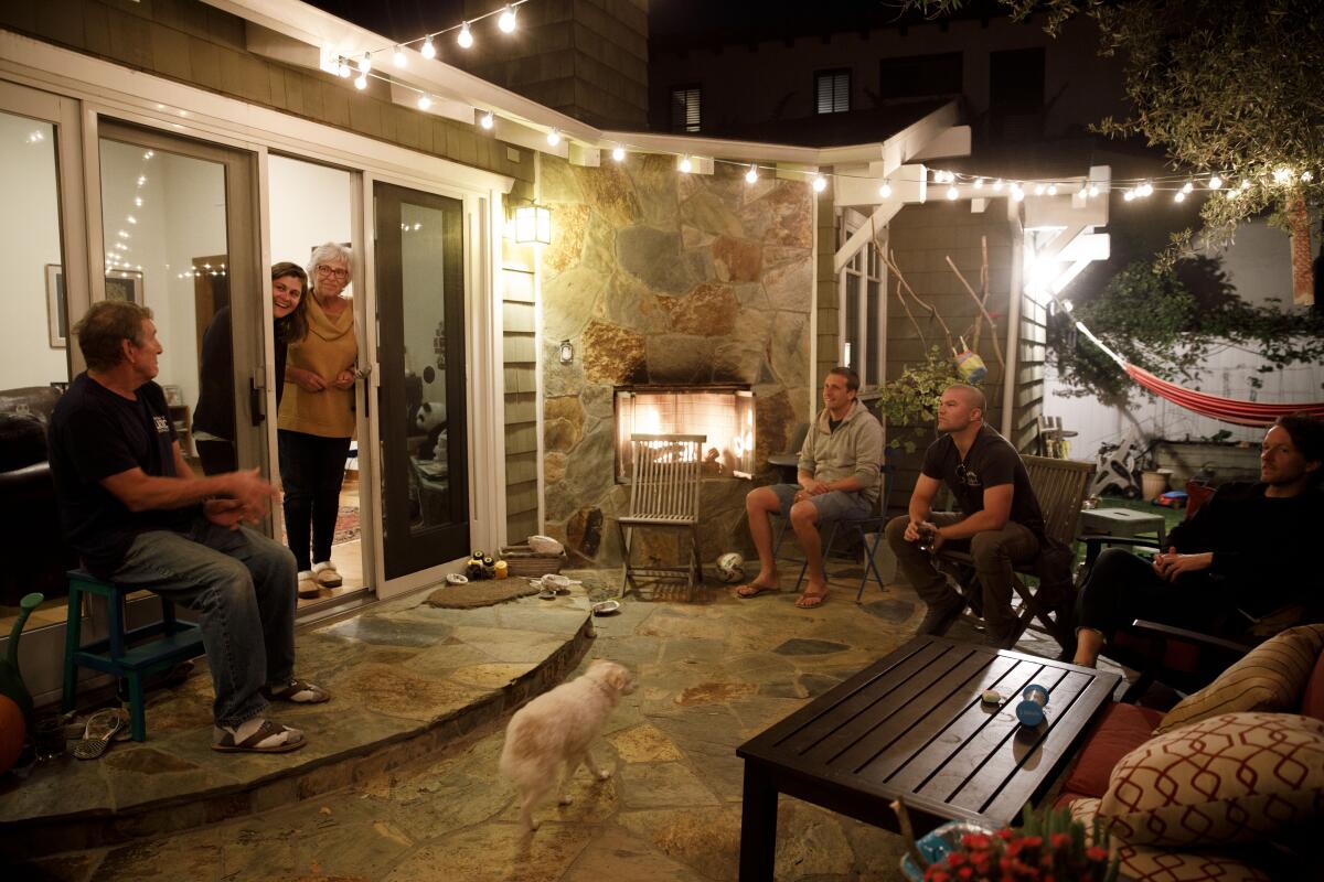 From left, Terry Herzik, Alyson Bourne, Deborah Herzik and doctors Andrew Herzik, Ben Musser and Craig Torres-Ness, and dog Little Dude, before they share dinner Monday.