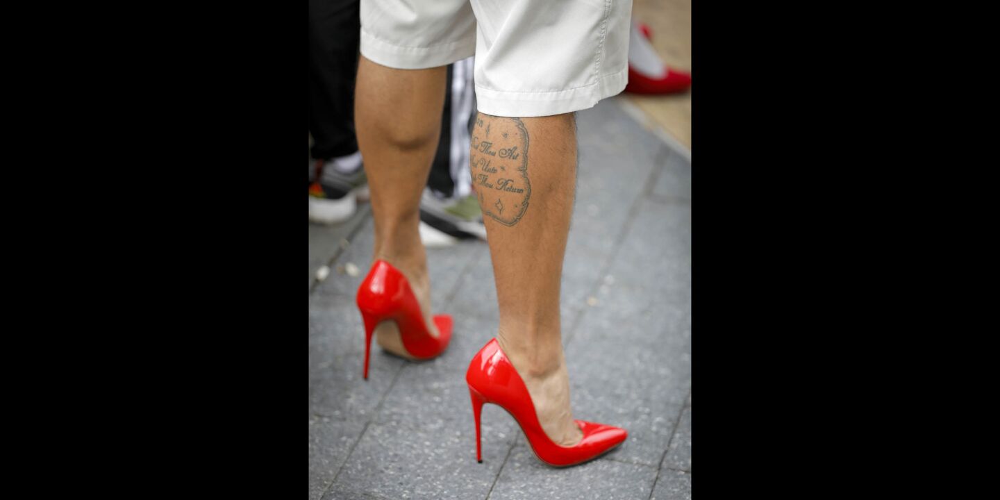 Pablo Zambrano of Orange, sporting red high heels was one of a couple of hundred people to walk through the Gaslamp Quarter during the YWCA'S 11th annual "Walk a Mile in Her Shoes," taking a stand against domestic violence.