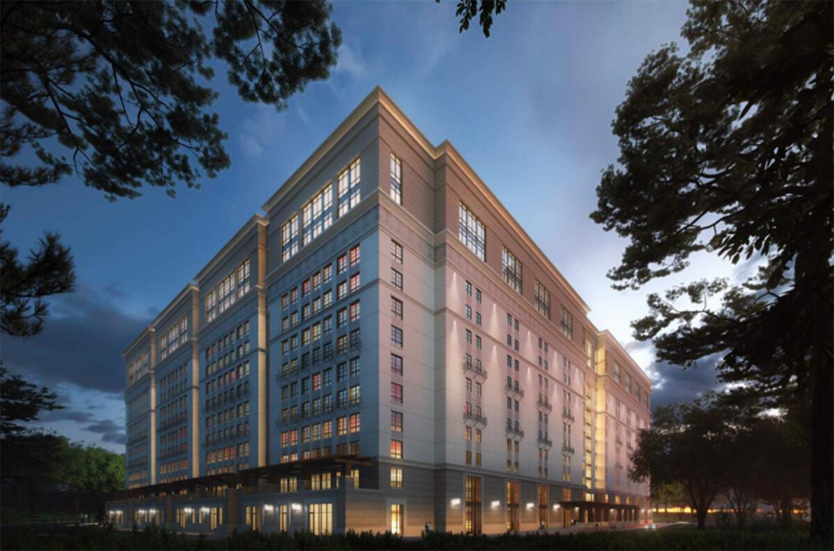 A rendering shows the exterior of the proposed Munger Hall at dusk