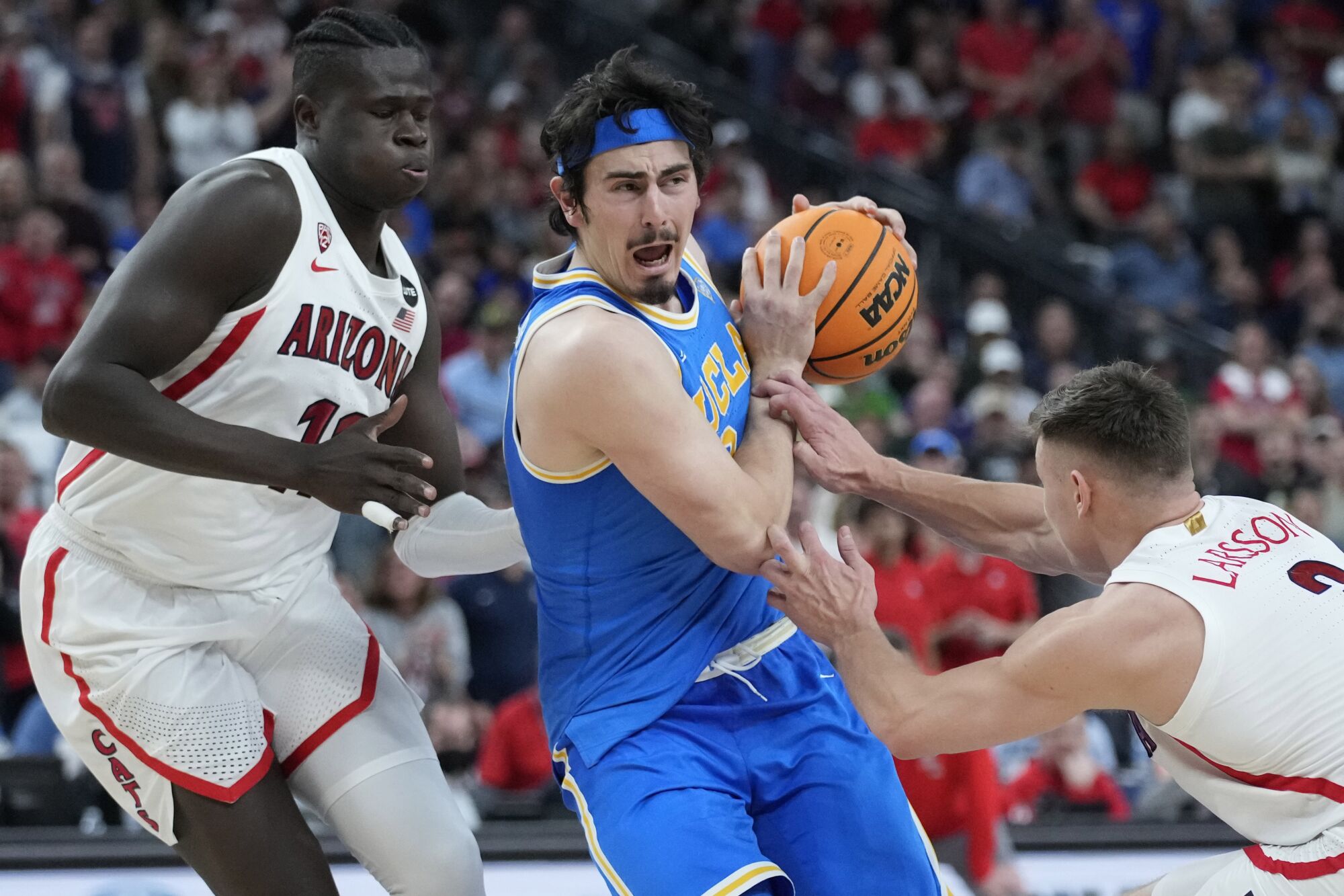 UCLA's Jaime Jaquez Jr. drives between Arizona's Oumar Ballo and Arizona's Pelle Larsson.