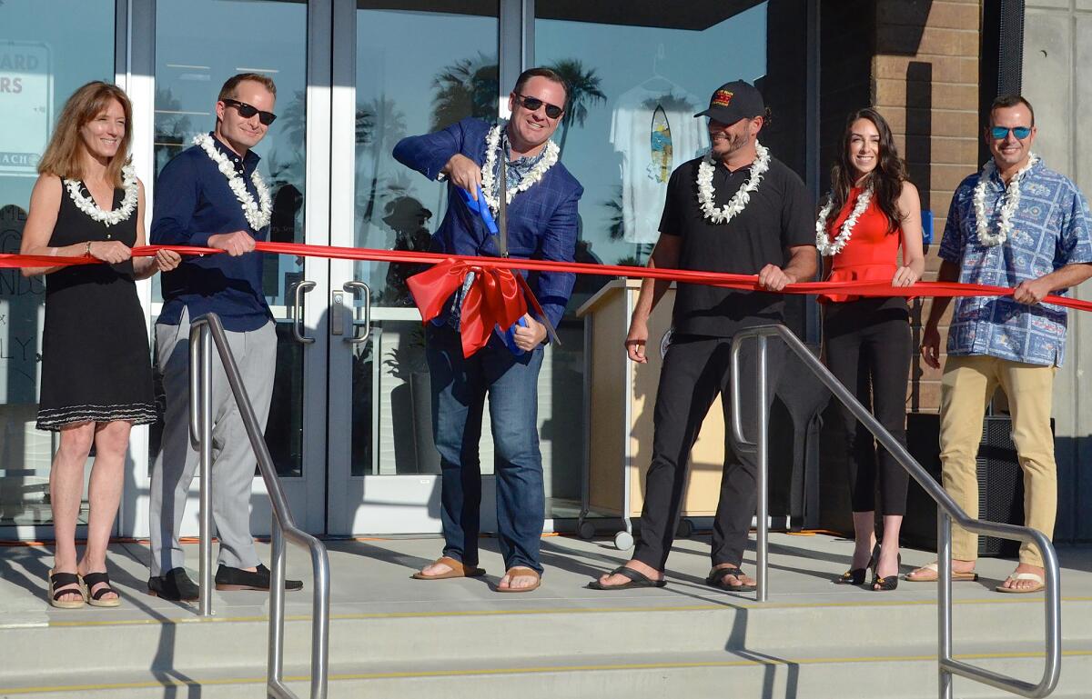 Newport Beach Mayor Will O'Neill cuts the ribbon for the new Newport Beach Junior Lifeguards facility.