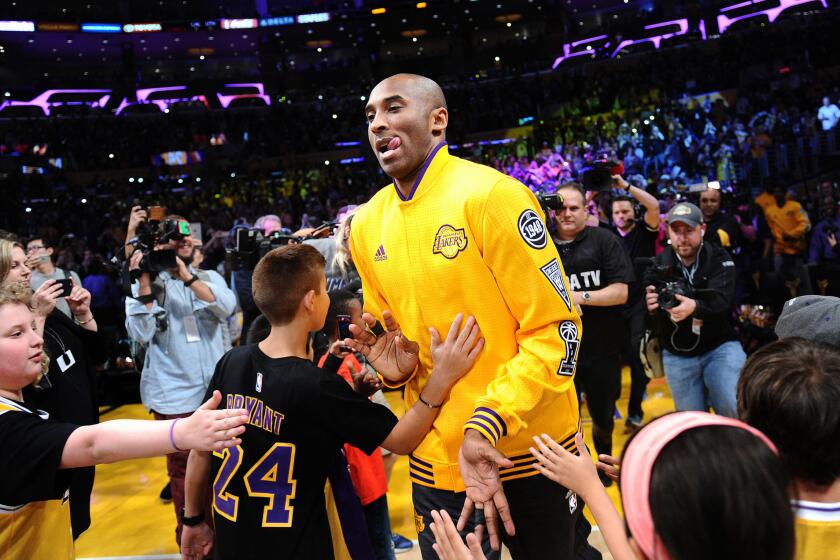 Kobe Bryant is welcomed onto the court for his farewell game at Staples Center on April 13.