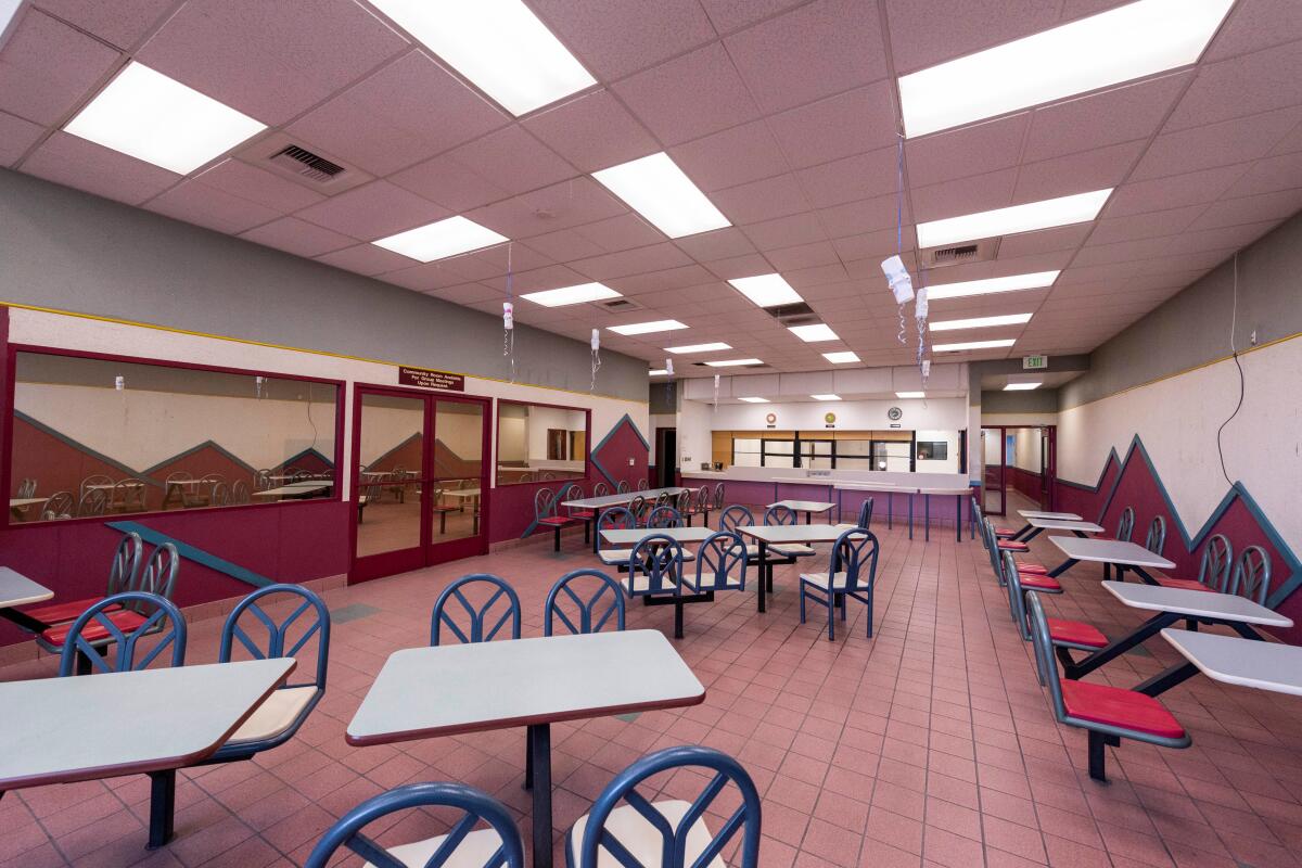 A room with drop ceilings also includes the kind of fixed furniture that is common to fast food restaurants