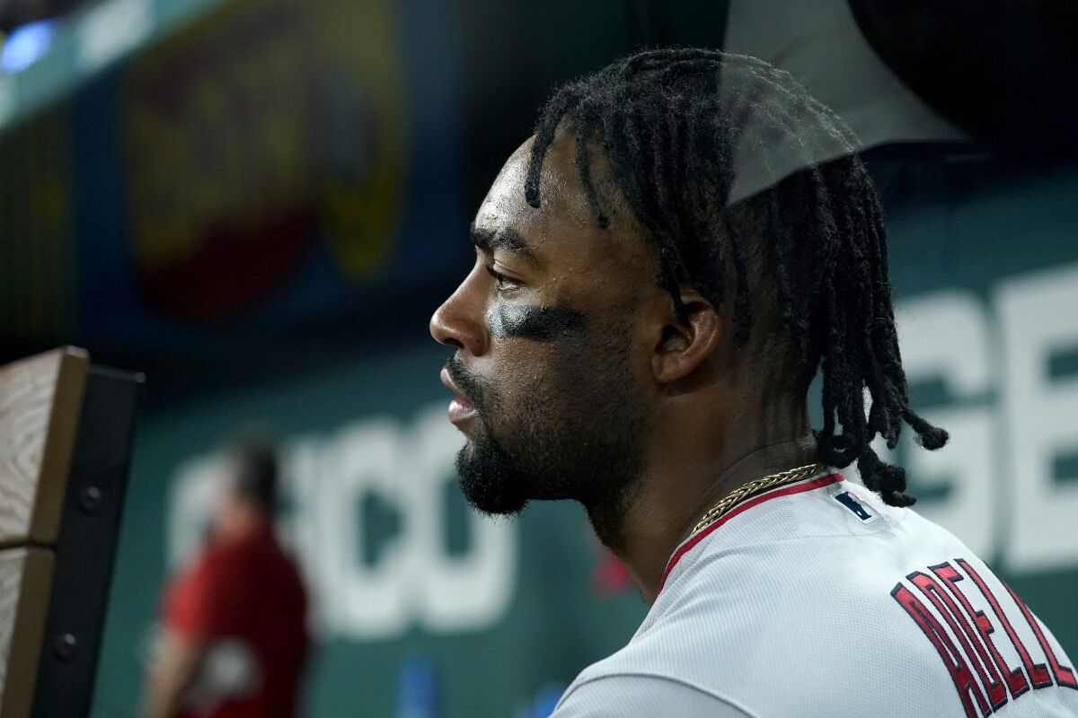Angels' Jo Adell sits in the dugout during a game.