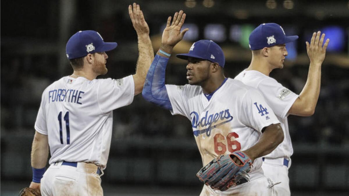 Logan Forsythe, Yasiel Puig and Corey Seager celebrate the Game 2 win over the Diamondbacks.