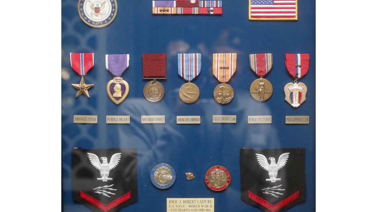 A collection of World War II veteran Bob Laizure's military medals is framed on a wall at his home in Huntington Beach.