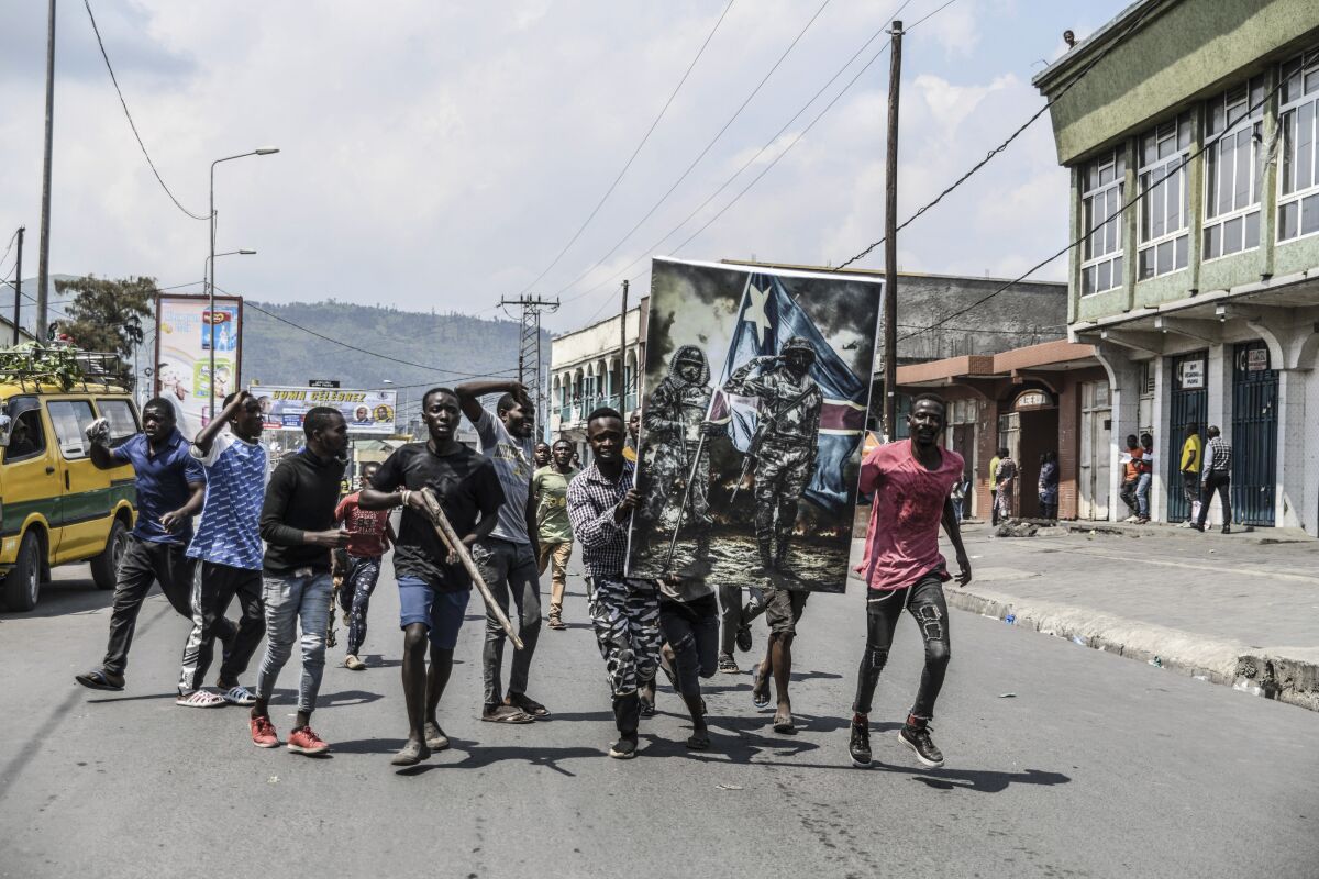 Demonstrators walk towards the border with Rwanda, in Goma, Democratic Republic of Congo, Wednesday June 15, 2022. Congo’s military is accusing Rwanda of “no less than an invasion” after a rebel group captured a key town in eastern Congo. The military confirmed late Monday that Bunagana had fallen into rebel hands earlier in the morning. (AP Photo/Moses Sawasawa)