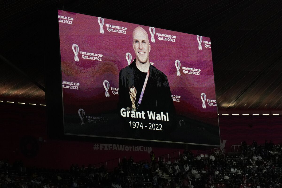 FILE - A tribute to journalist Grant Wahl is displayed on a screen before the World Cup quarterfinal soccer match between England and France, at the Al Bayt Stadium in Al Khor, Qatar, on Dec. 10, 2022. The late Grant Wahl will be honored with this year's Colin Jose Media Award, given to journalists who made long-term contributions to soccer in the United States.Wahl died at age 49 on Dec. 10 after collapsing while covering the World Cup quarterfinal between Argentina and the Netherlands at Lusail, Qatar. (AP Photo/Hassan Ammar, File)