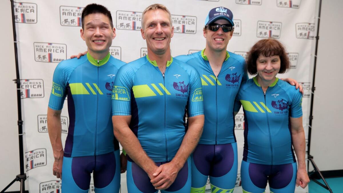Team Sea to See's blind members Jack Chen, Dan Berlin, Kyle Coon and Tina Ament pose for their official Race Across America portrait Thursday in Oceanside.