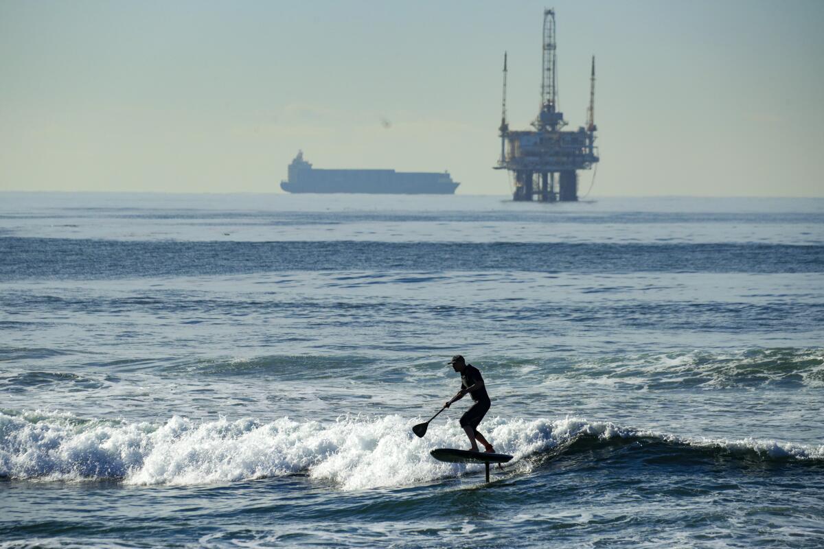 Dan Andersson, 45, enjoys riding morning waves along Bolsa Chica State Beach on Thursday.