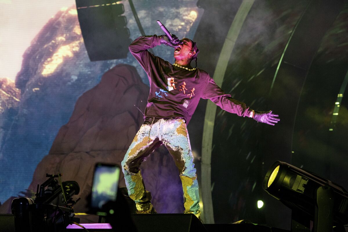 A male rapper performing onstage.