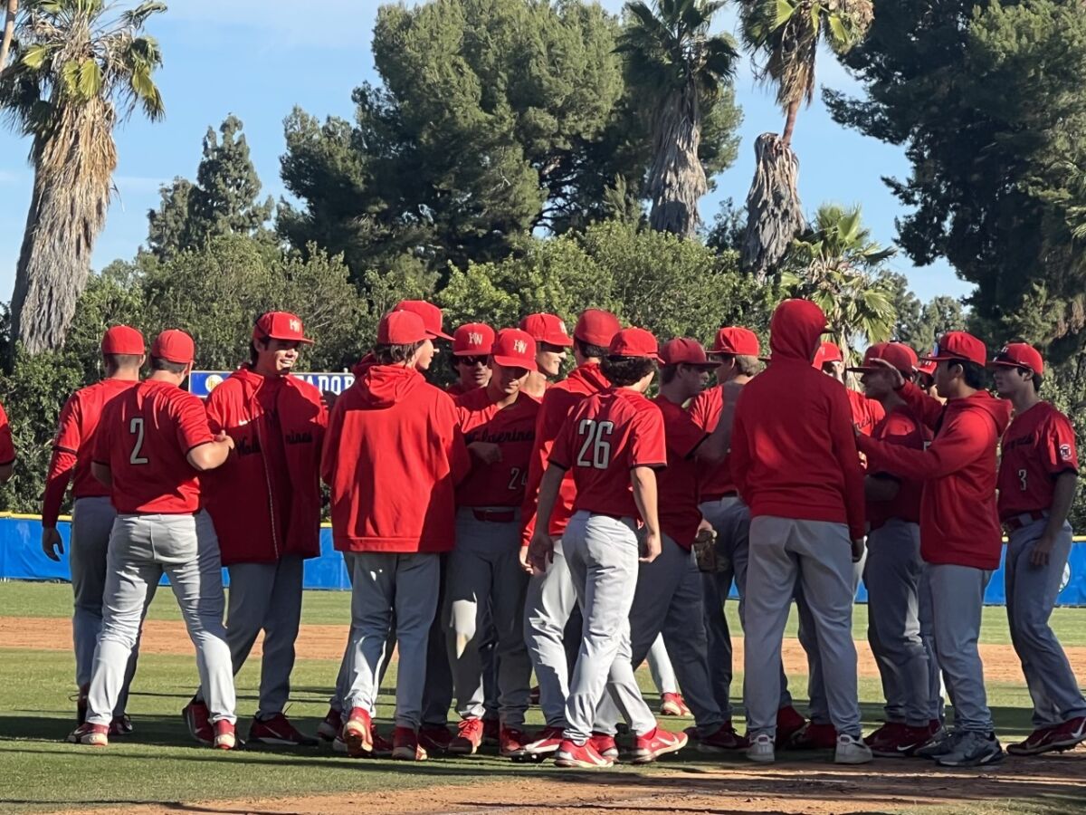 Harvard-Westlake players congratulate pitcher Avery Thau.