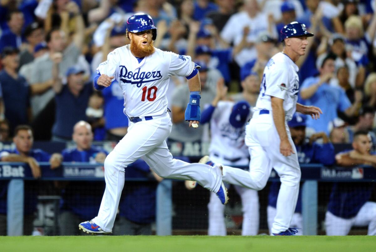 Dodgers baserunner Justin Turner rounds third base as he scores on a double by Andre Ethier in the fourth inning against the Mets in Game 2 of the NLDS on Saturday.