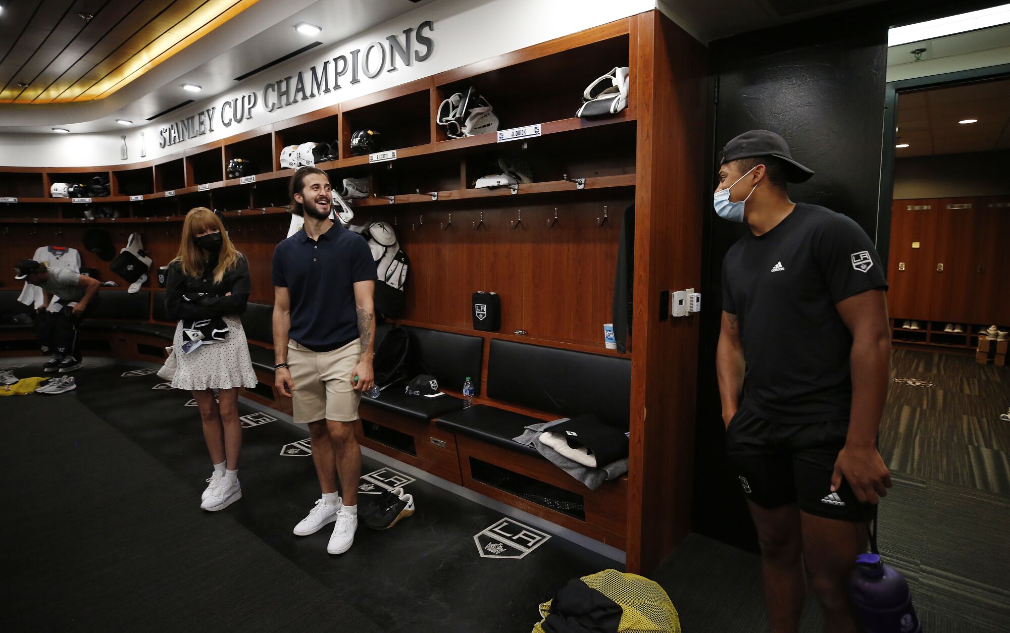 Phillip Danault and his wife, Marie, are greeted by Akil Thomas during a tour of the locker room.