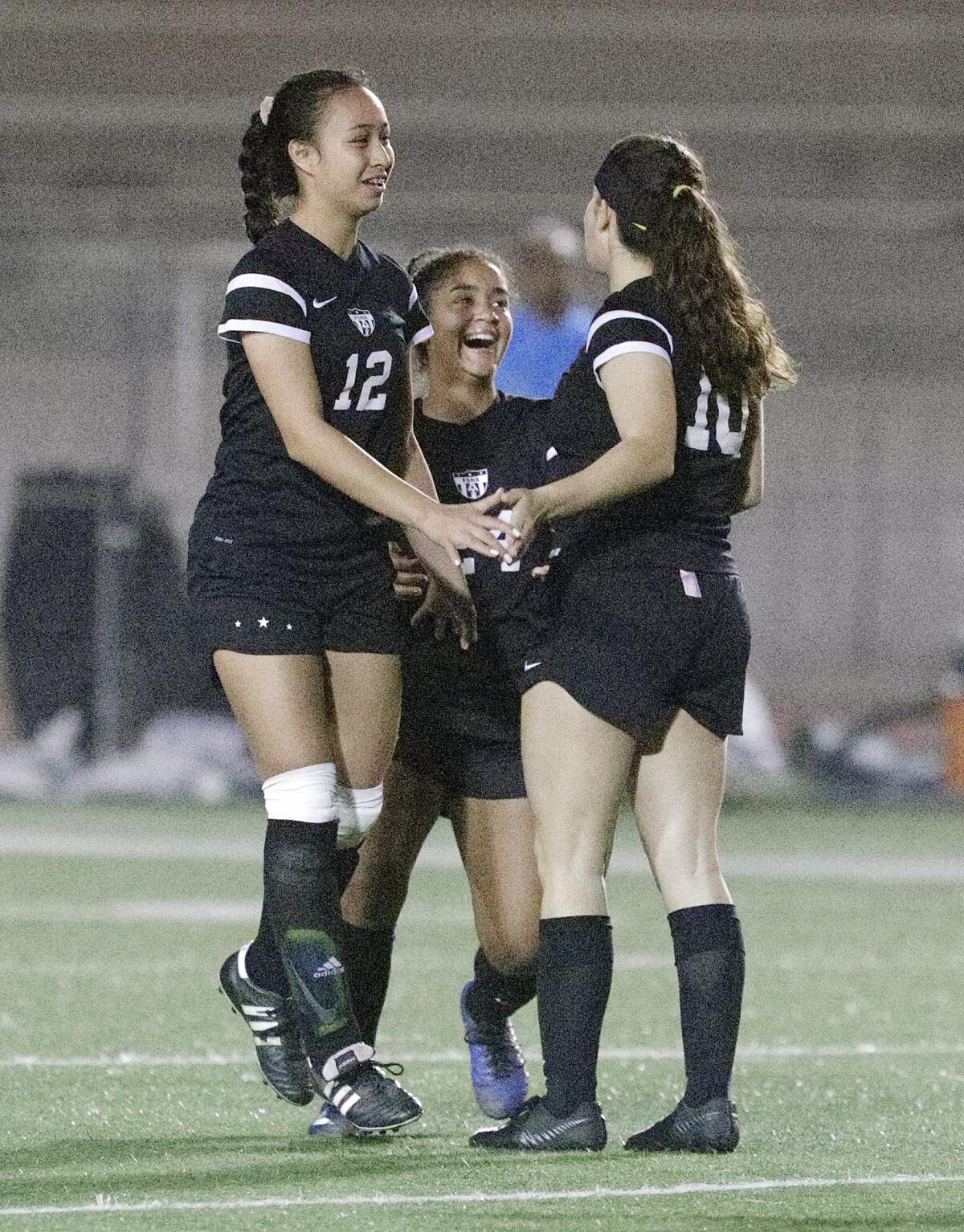Flintridge Sacred Heart's Therese Daniels and Alexis Gazmarian greet teammate Helena Locateli at mid field after she scored the first goal of the game against Sherman Oaks Notre Dame in a Mission League girls' soccer game at Occidental College in Los Angeles on Wednesday, January 8, 2020.