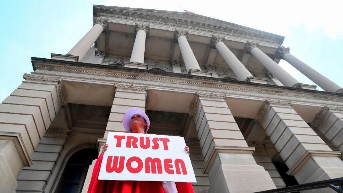 An abortion rights activist protests Georgia's new abortion law outside the Capitol in Atlanta on Thursday.