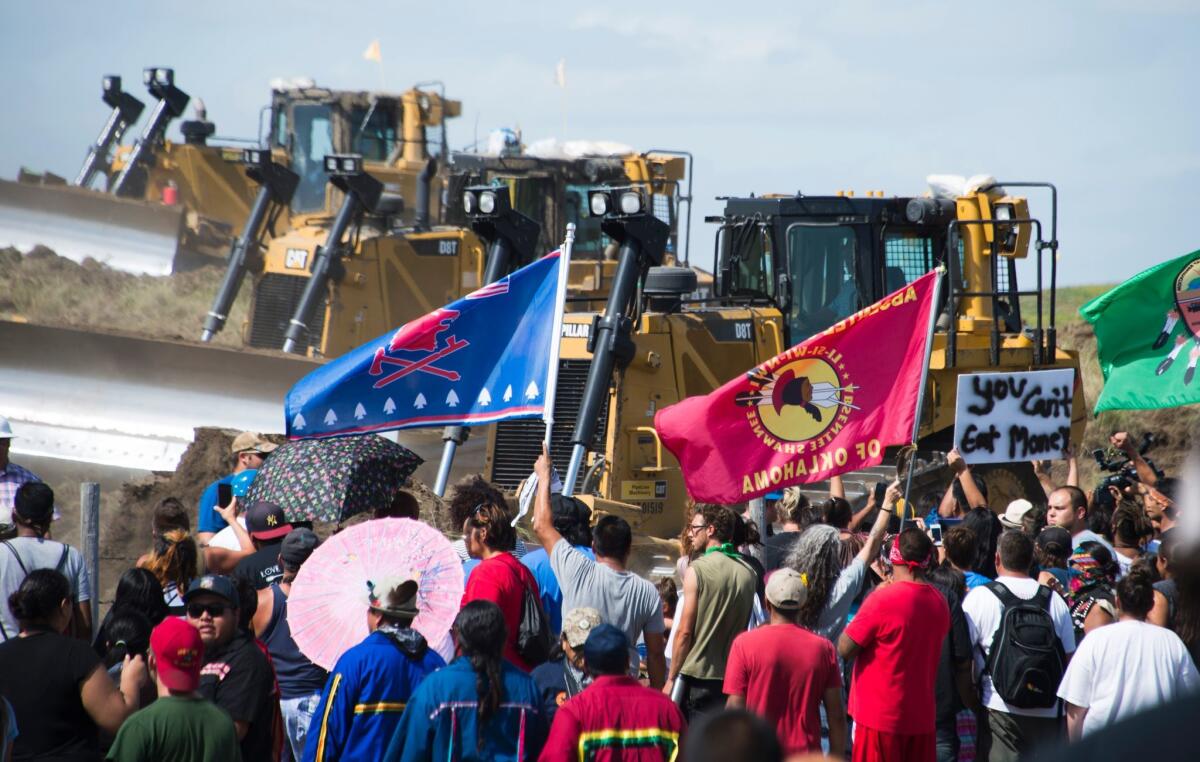 Members of the Standing Rock Sioux tribe and their supporters confront bulldozers working on the Dakota Access Pipeline near Cannon Ball, N.D.