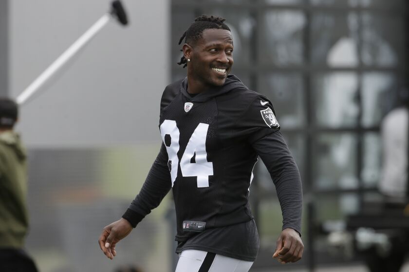 FILE - In this Aug. 20, 2019 file photo, Oakland Raiders' Antonio Brown smiles before stretching during NFL football practice in Alameda, Calif. Brown has asked the Oakland Raiders to release him a day after he was fined for an outburst at practice toward general manager Mike Mayock. Brown put a post on his Instagram account early Saturday, Sept. 7 morning saying he's not made but wants the freedom to prove his skeptics wrong. The post ends with his request to be released.(AP Photo/Jeff Chiu, File)