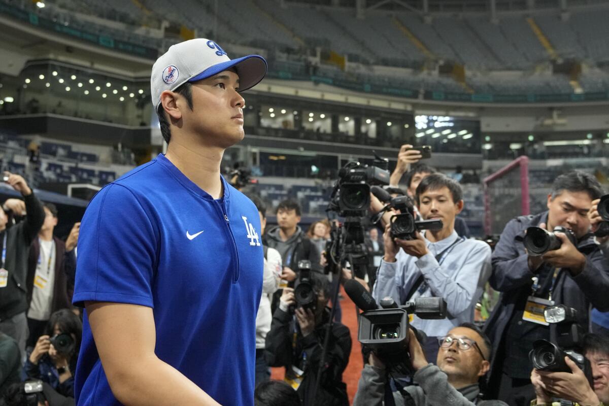 Dodgers star Shohei Ohtani takes the field for a workout at Gocheok Sky Dome in Seoul on Saturday.