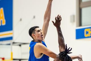 Aday Mara, a 7-foot-3 UCLA freshman, takes a shot during practice.