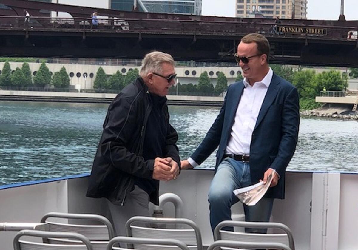 Peyton Manning, right, hangs out with legendary Bears coach Mike Ditka on the Chicago River.