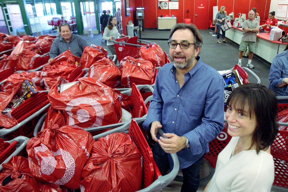 Michael and Lauren Hissrich, of Lake Hollywood, at Target with a few dozen carts filled with toys they just purchased with donation money in Burbank on Monday, December 8, 2014. Michael and Lauren Hissrich, of Lake Hollywood, with their friend Michelle Lankwarden, of Sherman Oaks with several friends spent $15,000 in donations to purchase toys and sundries at Target to donate to charities.