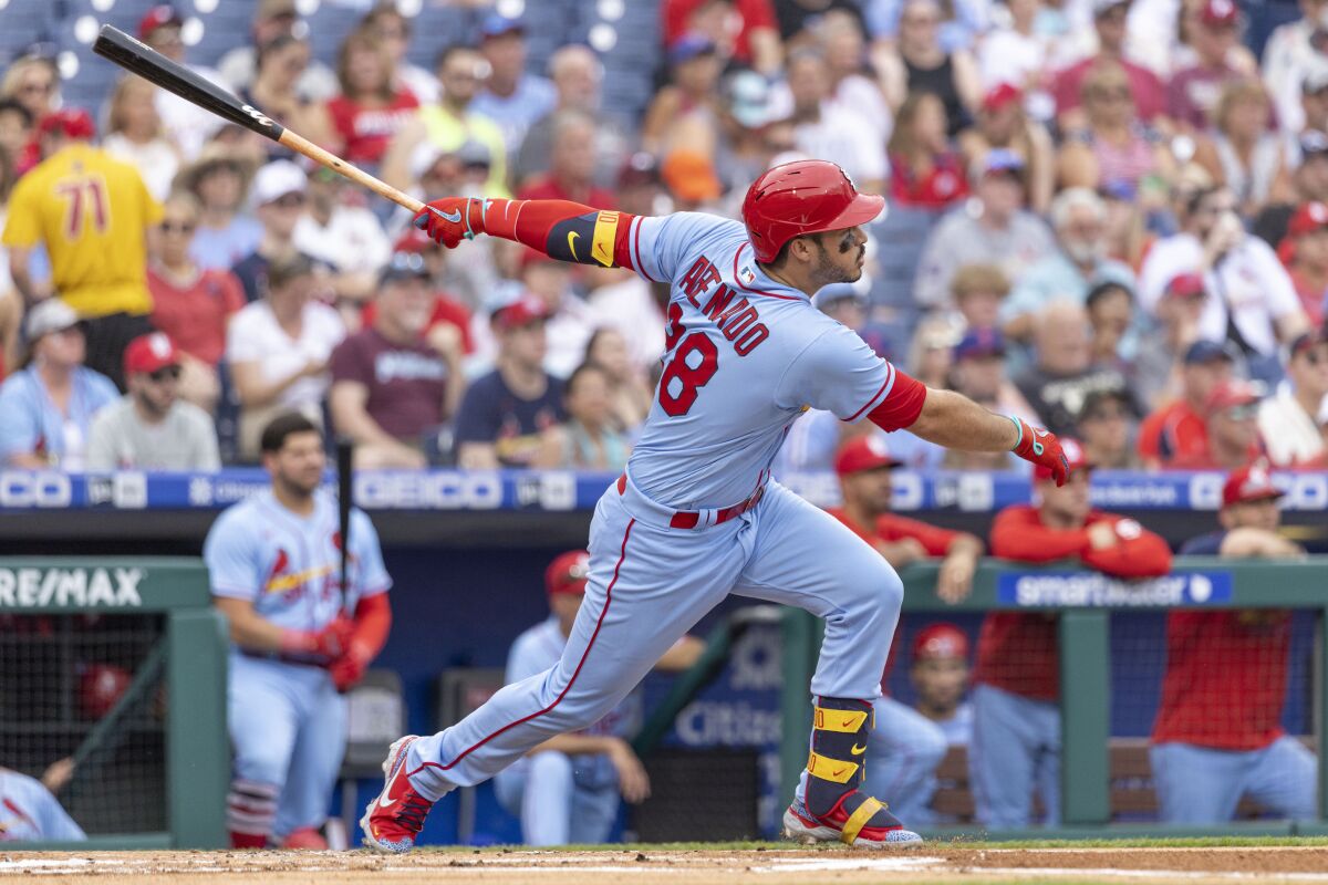 St. Louis Cardinals' Nolan Arenado (28) follows through on a two run home run during the first inning of a baseball game against the Philadelphia Phillies, Saturday, July 2, 2022, in Philadelphia. (AP Photo/Laurence Kesterson)